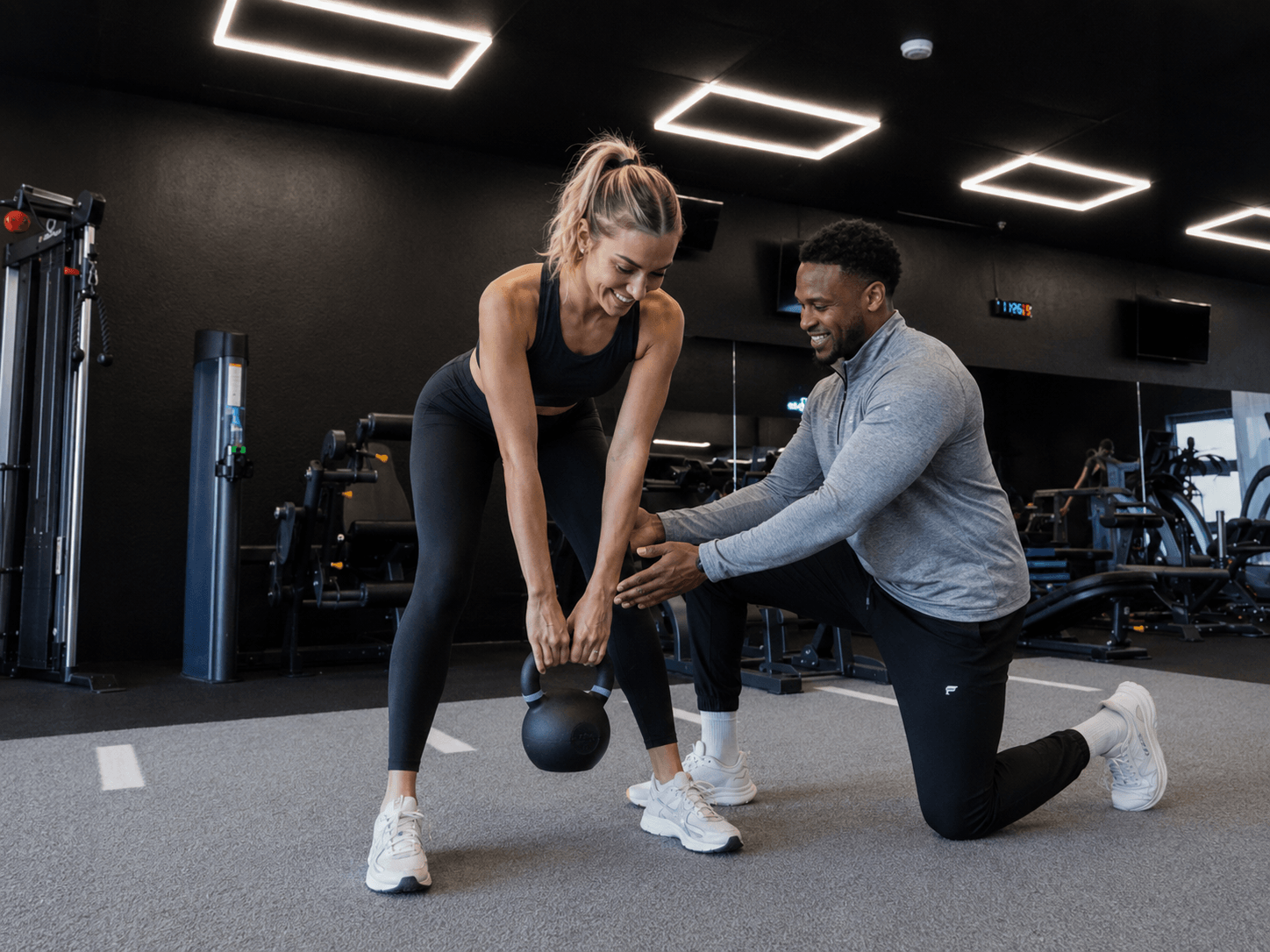 Personal trainer coaching a client through a workout